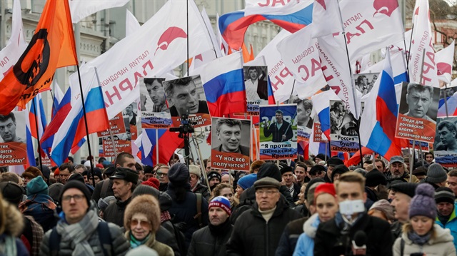 Opposition supporters hold portraits of Kremlin critic Boris Nemtsov during a rally