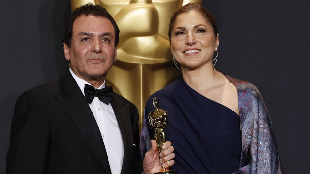 Anousheh Ansari and Firouz Naderi pose with the Oscar they accepted on behalf of Asghar Farhadi