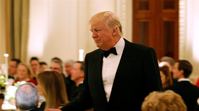 U.S. President Donald Trump walks after speaking during the Governor's Dinner