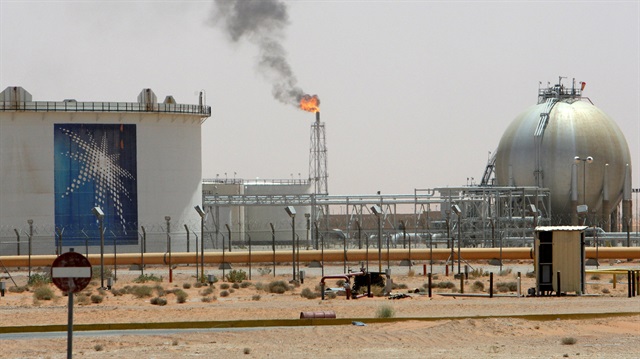 A gas flame is seen in the desert near the Khurais oilfield, Saudi Arabia