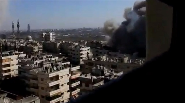 A still image taken from a video uploaded to a social media website shows Assad bombardment on Homs, Syria