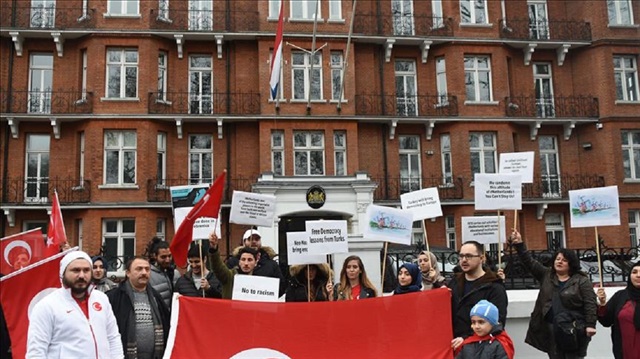 Members of Turkish Student Union of UK (TUSU) hold Turkish flags during a protest against Dutch authorities to show solidarity with the Turkish Foreign Minister Mevlut Cavusoglu and Turkish Family Minister Fatma Betul Sayan Kaya, in front of the Dutch Embassy in London, United Kingdom