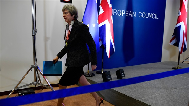 Britain's Prime Minister Theresa May leaves a news conference during the EU Summit 