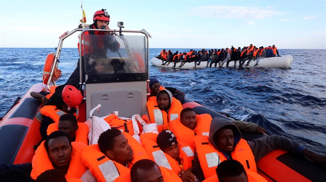 Sub-saharan migrants are seen aboard an overcrowded raft
