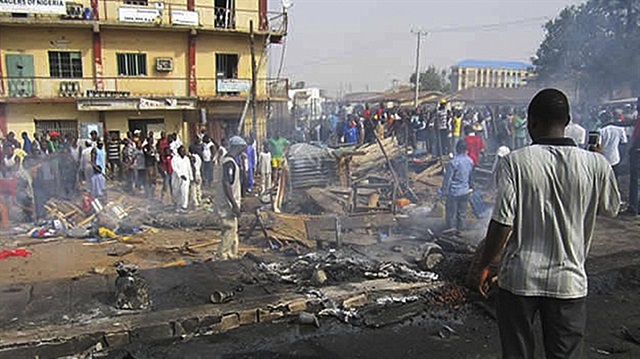 Nigerians survey the scene of a bomb blast in the northern city of Kaduna