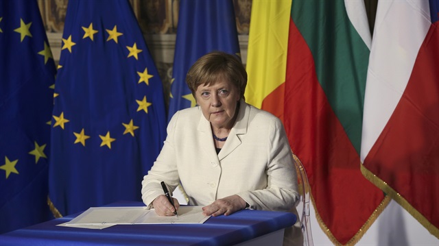 German Chancellor Angela Merkel signs document during the EU leaders meeting 