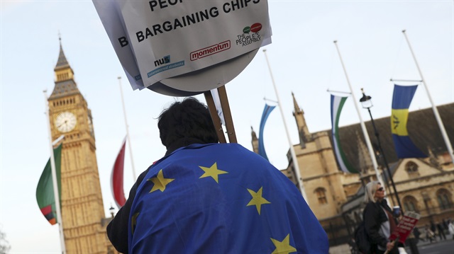  A demonstrator holds a placard during a protest in favour of amendments to the Brexit Bill outside the Houses of Parliament, in London

