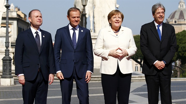 (from L to R) Malta's Prime Minister Joseph Muscat, European Council President Donald Tusk, German Chancellor Angela Merkel and Italy's Prime Minister Paolo Gentiloni pose for a picture outside the city hall "Campidoglio" (Capitoline Hill) as EU leaders arrive for a meeting on the 60th anniversary of the Treaty of Rome, in Rome, Italy
