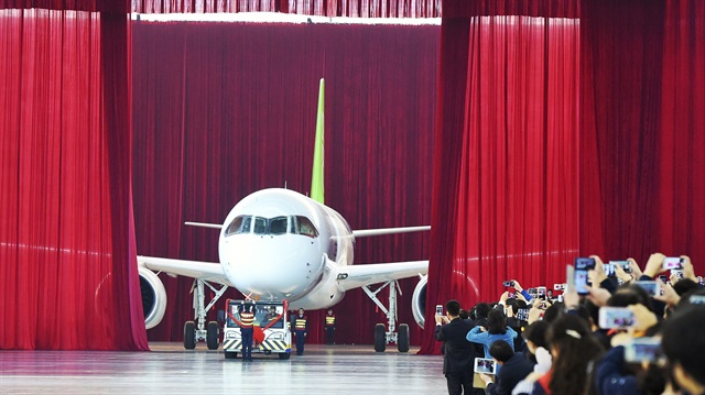 People take pictures and videos as the first C919 passenger jet made by the Commercial Aircraft Corp of China (Comac) is pulled out during a news conference at the company's factory in Shanghai, November 2, 2015. Comac rolled out China's first homemade 158-seated C919 narrow body jet, which is meant to rival similar models from Airbus Group and Boeing Co. State television also showed footage of the aircraft rolling off the assembly line in Comac's Shanghai factory. In a statement, the company said it had already received 517 orders for the aircraft mainly from domestic firms. 

