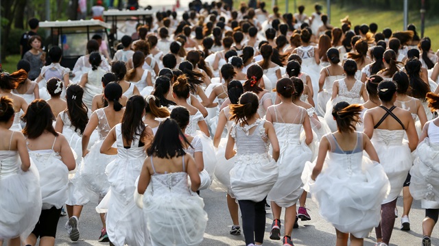 Brides-to-be participate in the "Running of the Brides" race in a park in Bangkok, Thailand 