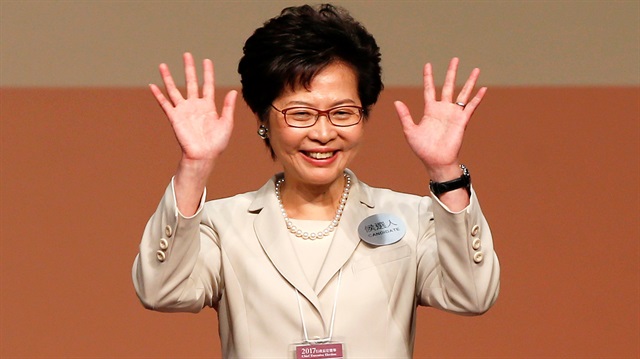Carrie Lam waves after she won the election for Hong Kong's Chief Executive in Hong Kong
