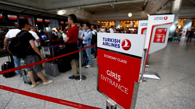 Passengers wait in line at a Turkish Airlines counter at the international departure 