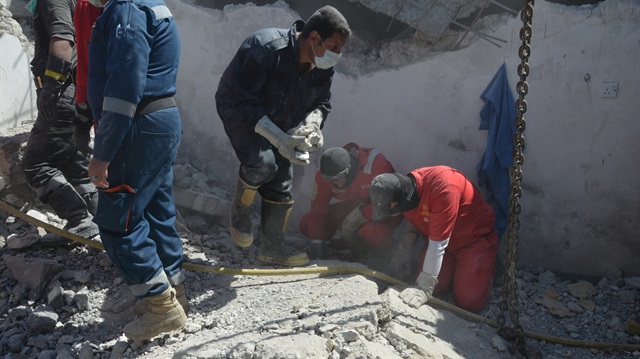 Iraqi firefighters search for bodies buried under the rubble in Mosul