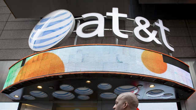 A man walks past the AT&T store in New York's Times Square