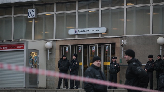Police officers take security measures outside a subway station in St Petersburg.