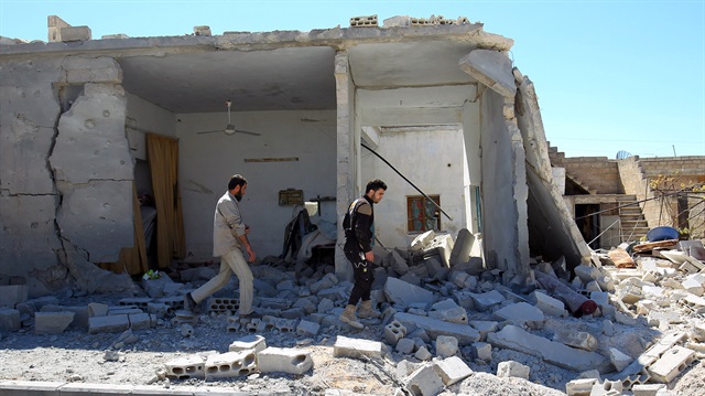 Civil defense members inspect the damage at a site hit by airstrikes on Tuesda