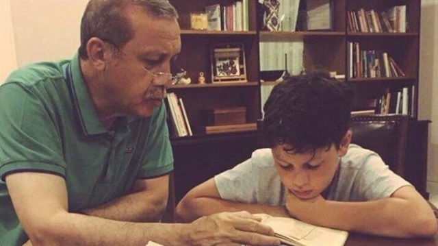 A photograph showing President Recep Tayyip Erdoğan reading the Quran to his grandson