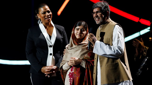 Nobel Peace Prize laureate Yousafzai and Queen Latifah look on as fellow laureate Satyarthi speaks at the Nobel Peace Prize Concert in Oslo.