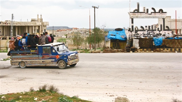 Chemical gas attack survivors leave the town of Khan Shaykun, Idlib province, in a pick-up truck.