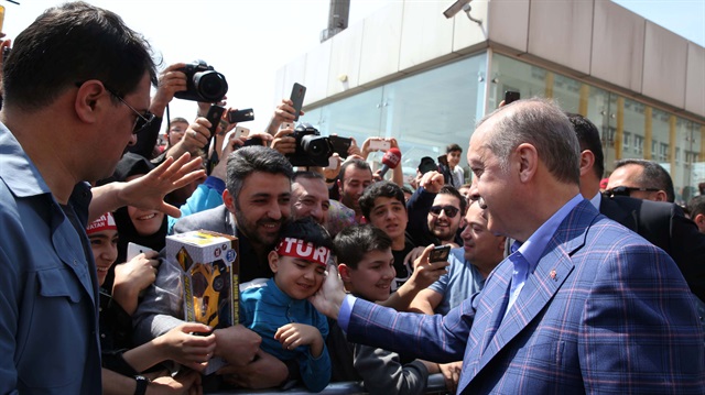 President Erdoğan greets his supporters outside of a polling station during a referendum in Istanbul.