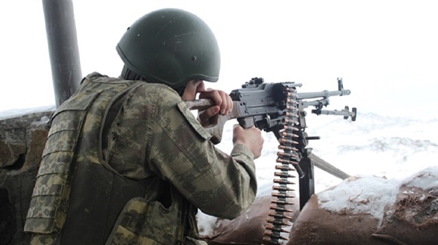 A Turkish soldiers fires at PKK targets in southeastern Turkey