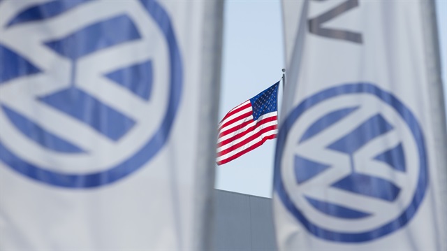 An American flag flies next to a Volkswagen car dealership in San Diego