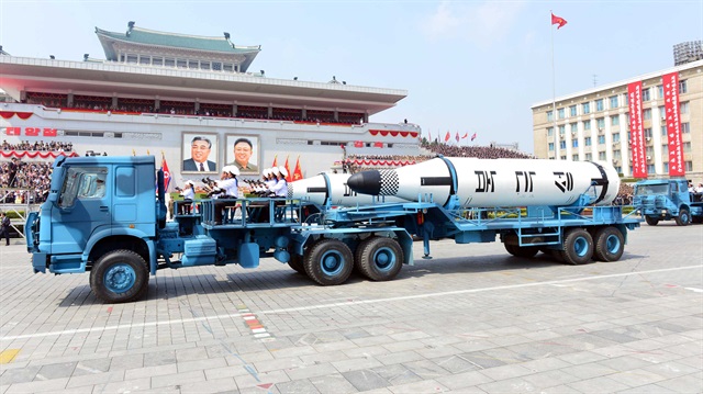 Military vehicles carry missiles with characters reading "Pukkuksong" during a military parade in Pyongyang