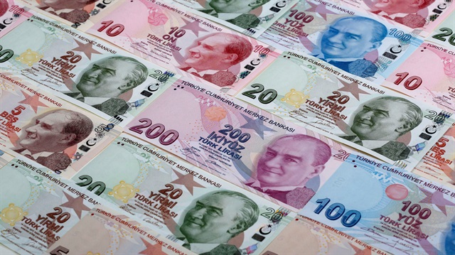 Turkish lira banknotes are seen in a photo illustration
