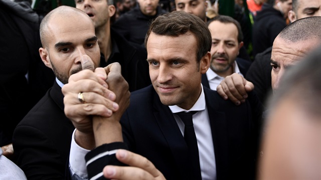 Emmanuel Macron, head of the political movement En Marche !, or Onwards !, and candidate for the 2017 presidential election, speaks with residents during a campaign visit in Sarcelles.
