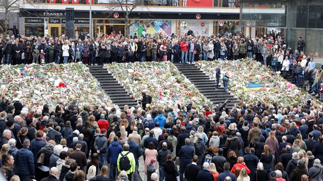 People observe a minute of silence at noon on Sergels Torg to remember the victims of Friday's attack on Drottninggatan, Stockholm.