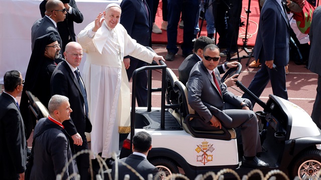 Pope Francis gestures as he arrives to hold a mass in Cairo, Egypt