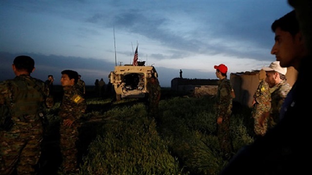 PKK/PYD terrorists kept watch on the border with U.S. troops near Turkey's southern border. 