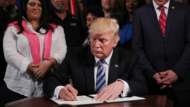 U.S. President Donald Trump signs an Executive Order