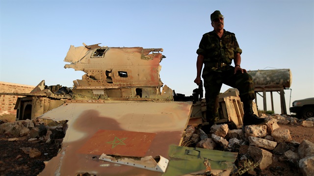 A member of the Polisario stands beside the wreckage of a MOroccan air force F-5 in Western Sahara