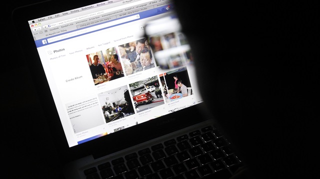 Man uses Facebook on laptop