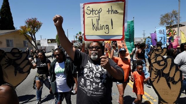 Protesters march from the intersection of Florence and Normandie Avenue, the flashpoint where the riots started 25 years ago, to a nearby park for a rally to remember and honor the victims of the 1992 Los Angeles riots in Los Angeles, California, U.S., April 29, 2017.