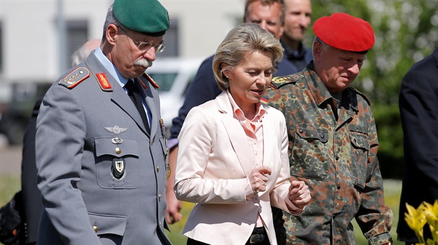 German Defence Minister Ursula von der Leyen (C) walks with General Joerg Vollmer, General Inspector of the German Land Army (L), and General Volker Wieker, Inspector General of Germany's Armed Forces (R)