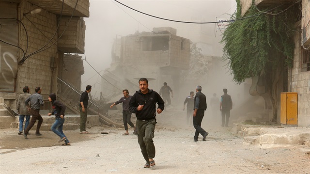 Smoke rises after Assad Regime's airstrike hit residential areas at the Saqba town of Eastern Ghouta in Damascus, Syria on May 1, 2017.