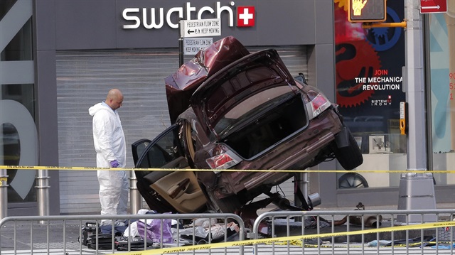 The remains of a vehicle involved in crash are cordoned off in Times Square in New York.