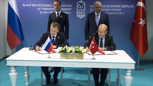 Turkish Deputy Prime Minister Mehmet Şimşek (R) and Russian Deputy Prime Minister Arkady Dvorkovich (L) sign a joint declaration between Turkey and Russia as Prime Minister of Turkey Binali Yıldırım and Russian Prime Minister Dmitry Medvedev stand behind them within the 25th Anniversary Summit of the Organization of the Black Sea Economic Cooperation in Istanbul, Turkey on May 22, 2017.