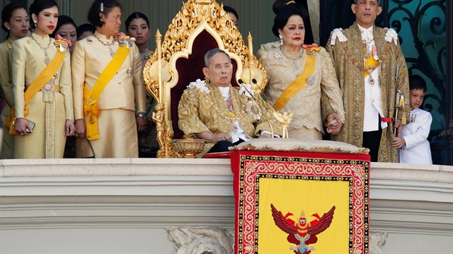 File photo of Thailand's King Bhumibol accompanied by members of the royal family as he delivers birthday speech from balcony of Grand Palace in Bangkok