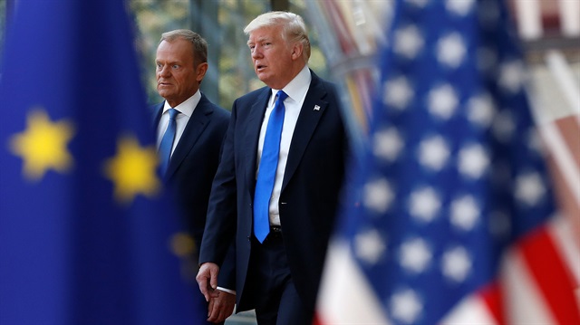 U.S. President Donald Trump walks with the President of the European Council Donald Tusk in Brussels.