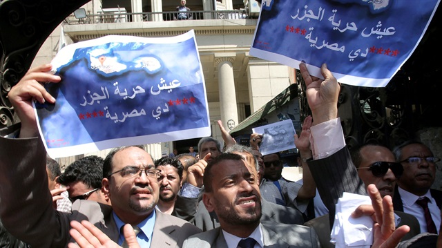 File Photo: Protesters shout slogans and hold a banner that reads in Arabic 'two Red Sea islands are Egyptian', against a deal that sees Egypt cede sovereignty over two Red Sea islands to Saudi Arabia.