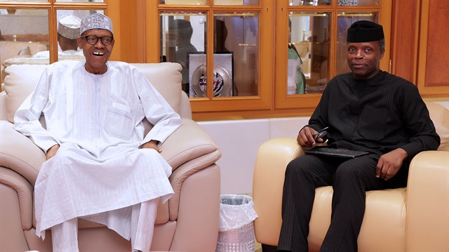 Nigerian President Muhammadu Buhari (L) smiles next to his deputy Yemi Osibanjo in Abuja,.