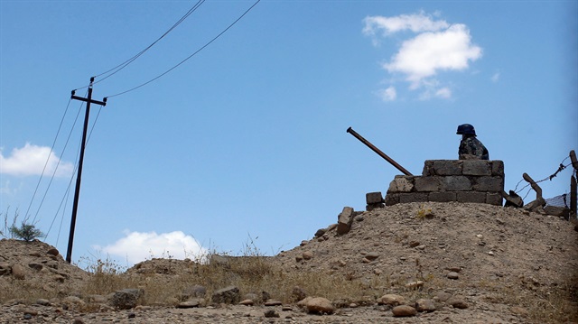 A member of Iraqi security forces mans an observation point beside a highway 