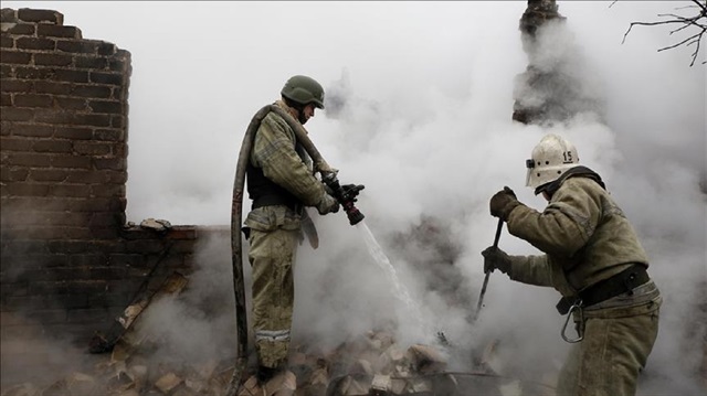 Ukrainian rescuers try to extinguish a fire caused by pro-Russian separatists' shellings at Avdeevka district of Donetsk, Ukraine on February 25, 2017.