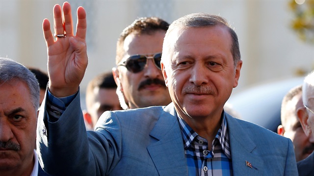 Turkey's President Tayyip Erdoğan greets his supporters as he leaves a mosque after the Eid al-Fitr prayers in Istanbul

