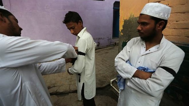 Several leading Muslim organizations and individuals had asked Muslims to wear the black bands during special Eid prayers as a message to the government. 