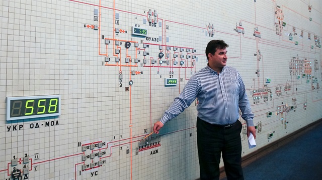 A dispatcher shows a diagram of power lines inside the control room 