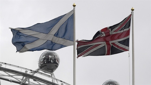 The British Union Flag (R) and a Scottish Saltire flag fly above the Scottish Office in Whitehall.
